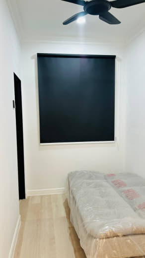 A home office with sleek, minimalist roller blinds