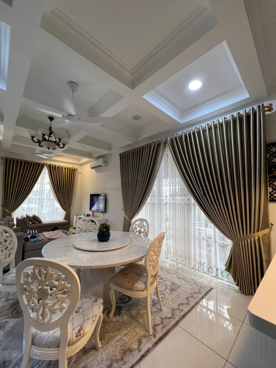 A dining area with airy, light-filtering curtains