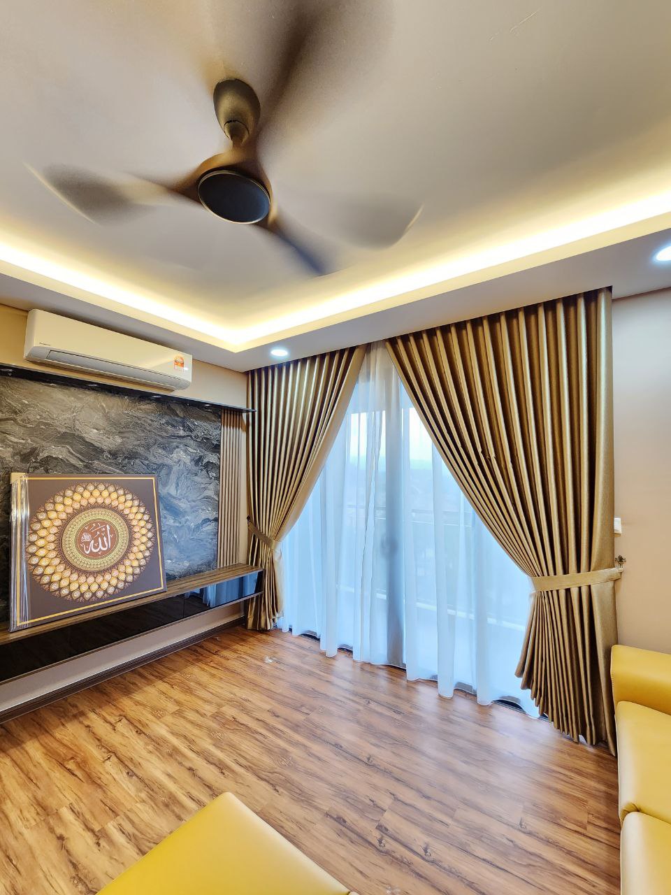 A condo living space with a combination of sheer and blackout curtains